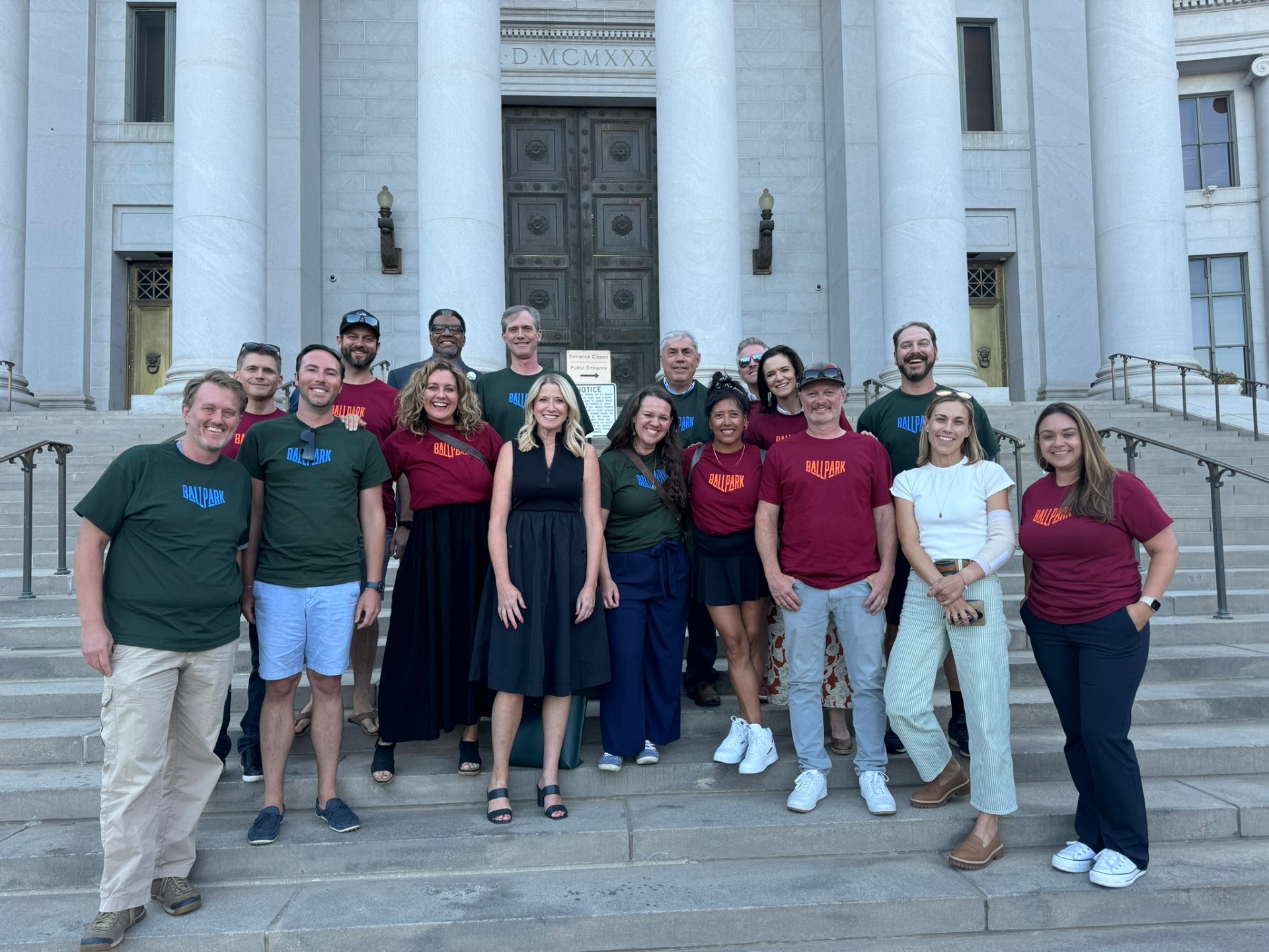 Ballpark Collective members on the Denver City and County Building steps in Ballpark district t-shirts