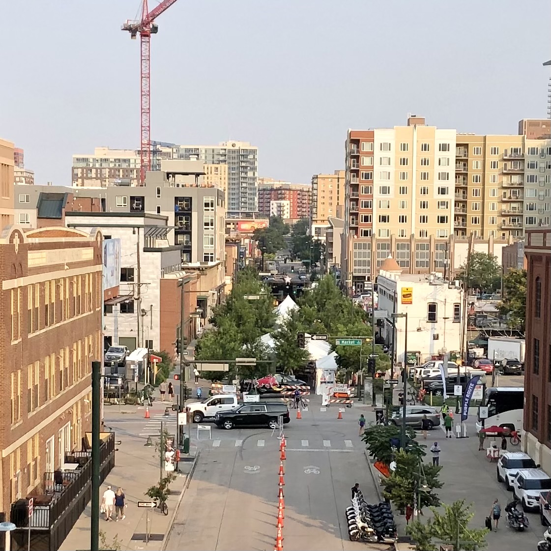 Tree-lined Ballpark District street during a community event