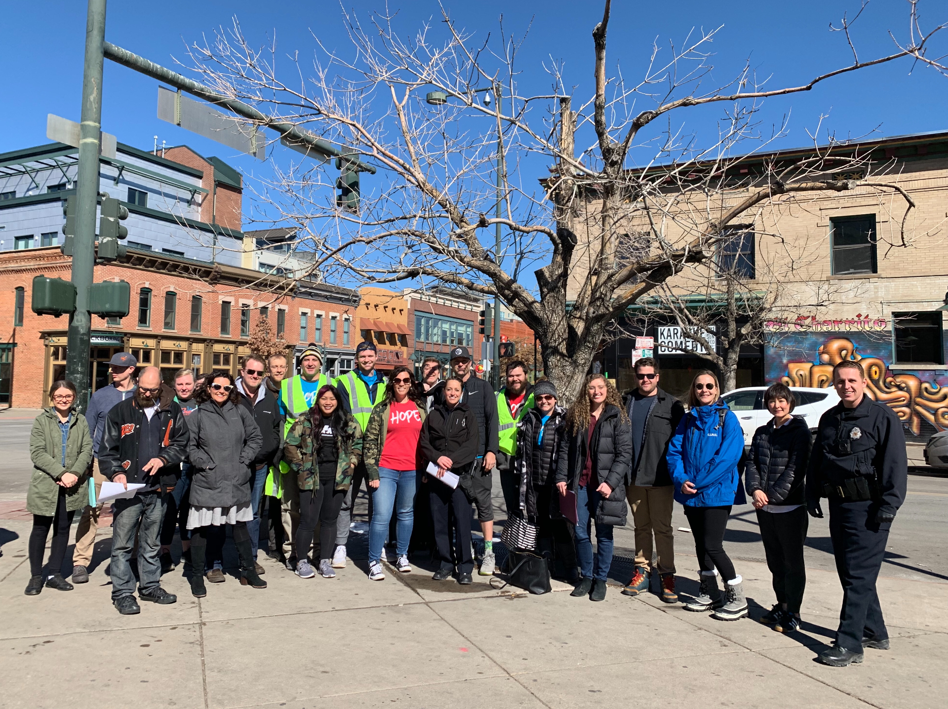 Volunteers gathered on a Ballpark District sidewalk for a neighborhood cleanup