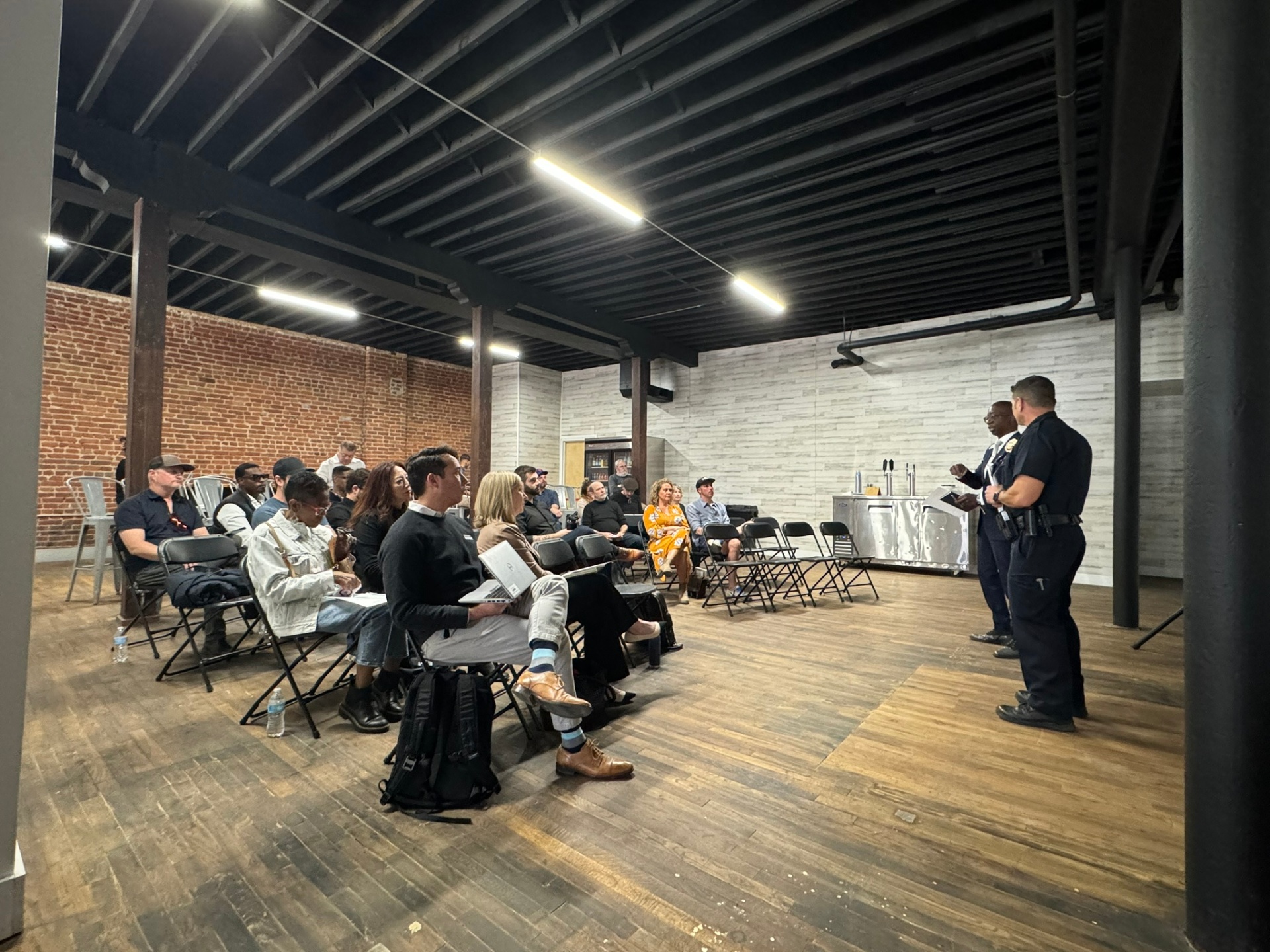 Denver Police officers presenting to neighbors at a Ballpark District safety meeting